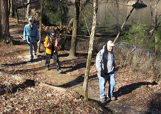 The Sentinel-Record/Richard Rasmussen OUT AND ABOUT: From left, Rick Crites, Kay Ford and Brad Fountain take a hike at Northwoods Trails on Tuesday. Hikers and Mountain Bikers have been utilizing the first phase of the trail system since it was opened in mid-November.