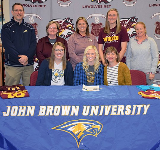 Submitted photo JBU BOUND: Lake Hamilton senior setter Morgan Fincham, center, signs her letter of intent John Brown University's volleyball program Tuesday morning at Lake Hamilton High School. Fincham is accompanied in front by her sister, Suzanne Raines, left, and mother, Amy Fincham; and back, from left, JBU head volleyball coach Ken Carver, Lake Hamilton junior high head volleyball coach Stacey Scott, Lake Hamilton high school head coach Karen Smith, Jessica McBride and assistant coach Amy Teague.