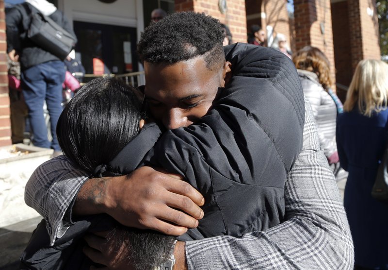 Marcus Martin, who was injured during the 2017 car attack, hugs a supporter after a jury recommended life plus 419 years for James Alex Fields Jr. for the death of Heather Heyer as well as several other charges related to the Unite the Right rally in 2017 in Charlottesville, Va., Tuesday, Dec. 11, 2018. (AP Photo/Steve Helber)