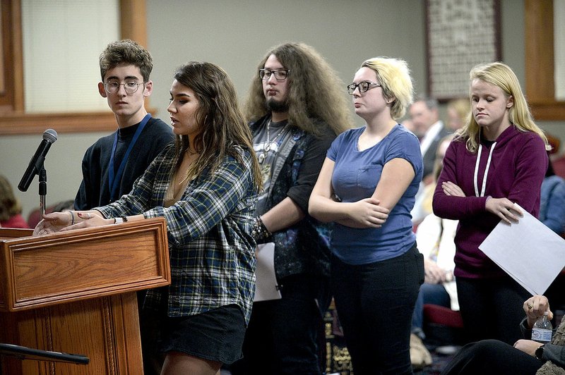 NWA Democrat-Gazette/ANDY SHUPE Halle Roberts (second from left), editor-in-chief of the Har-Ber Herald, the student newspaper at Har-Ber High School, speaks Tuesday to the Springdale School Board alongside members of the Herald staff and the school's yearbook staff during a public comment portion of the board's meeting in Springdale.