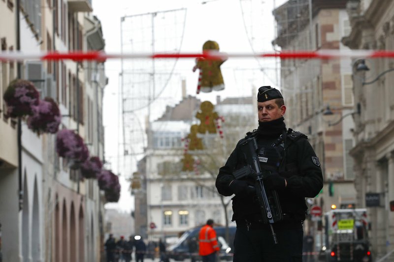 A French gendarme patrols in the streets of the city of Strasbourg, eastern France, following a shooting, Wednesday, Dec. 12, 2018. A man who had been flagged as a possible extremist sprayed gunfire near the city of Strasbourg's famous Christmas market Tuesday, killing three people, wounding 12 and sparking a massive manhunt. France immediately raised its terror alert level. (AP Photo/Christophe Ena)