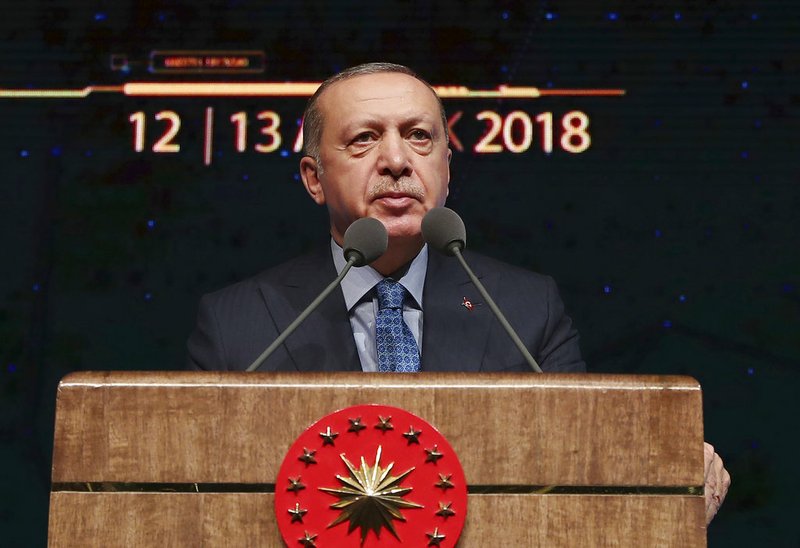 Turkey's President Recep Tayyip Erdogan delivers a speech during a defence industry meeting event in Ankara, Turkey, Wednesday, Dec. 12, 2018. Erdogan said Turkey will begin "within a few days" a new military operation to drive out U.S-backed Syrian Kurdish fighters in Syria, east of the Euphrates River. The move is likely to increase tensions between NATO allies, Turkey, and the United States. (Presidential Press Service via AP, Pool)