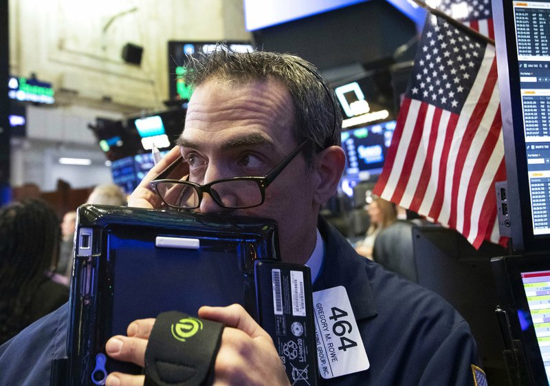 Trader Gregory Rowe works at the New York Stock Exchange, Wednesday, Dec. 12, 2018, in New York. (AP Photo/Mark Lennihan)