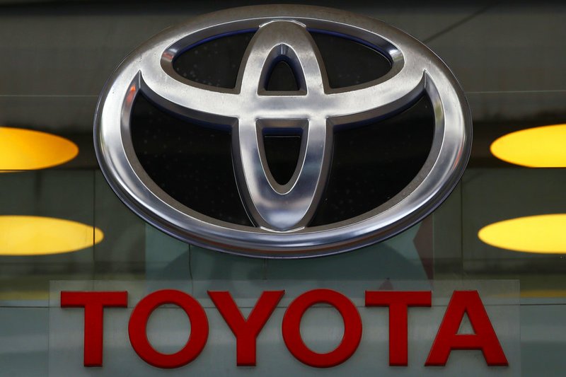 FILE - This Sept. 20, 2017, file photo shows the Toyota logo at their shop on the Champs Elysees Avenue in Paris. Toyota is recalling about 70,000 Toyota and Lexus brand vehicles in North America to replace air bag inflators that could explode and hurl shrapnel at drivers and passengers. The recall covers the 2003 to 2005 Corolla, the 2002 to 2005 Sequoia, the 2003 to 2005 Tundra and the 2002 to 2005 Lexus SC. (AP Photo/Francois Mori, File)