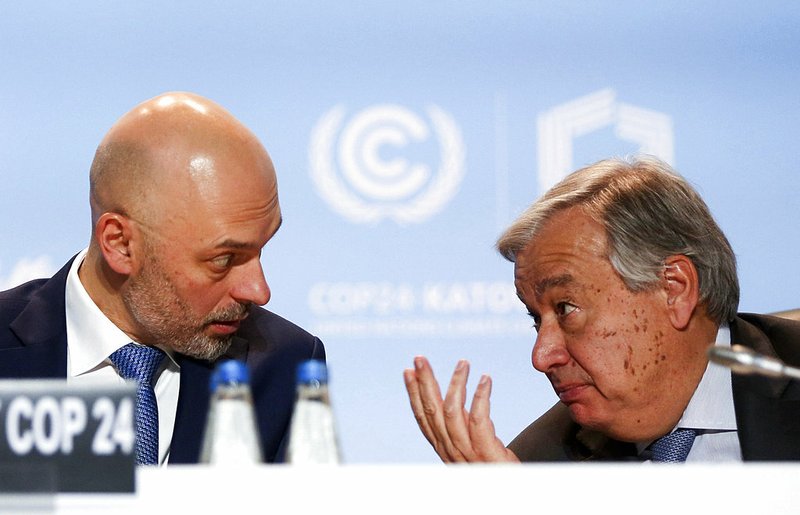 U.N. Secretary-General Antonio Guterres, right, talks to U.N. climate conference president, Poland's Deputy Environment Minister Michal Kurtyka, left, after flying back to the event to urge more effort from the negotiators as they seek ways of fighting climate change, in Katowice, Poland, Wednesday, Dec. 12, 2018.(AP Photo)