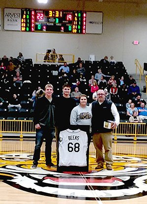 MARK HUMPHREY ENTERPRISE-LEADER Tampa Bay Rays left-handed pitcher Jalen Beeks, a 2011 graduate of Prairie Grove High School and former Arkansas Razorback, attended the Prairie Grove versus West Fork basketball games Friday, Dec. 7, 2018. At halftime of the boys' game, Beeks drew the winning ticket from a raffle of his Tampa Bay jersey No. 68 and presented the framed prize to Marcresa Hattenhauer, a band mom, who purchased the winning ticket. Participating in the drawing were (from left): Tiger catcher Couper Allen, Beeks, Hattenhauer, and Prairie Grove baseball coach Chris Mileham.