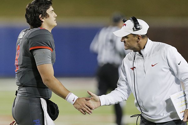 SMU head coach Chad Morris, right, gives encouragement to quarterback Ben Hicks (8) during the second half of an NCAA college football game against South Florida Saturday, Nov. 19, 2016, in Dallas. South Florida won 35-27. (AP Photo/Brandon Wade)