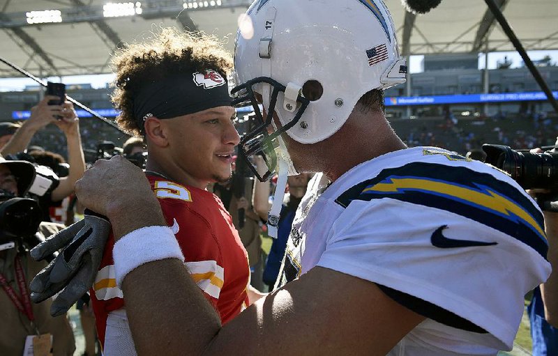 Kansas City Chiefs quarterback Patrick Mahomes (left) speaks with Los Angeles Chargers quarterback Philip Rivers after the Chiefs’  victory in Week 1. The teams meet again in a key AFC West matchup tonight in Kansas City. 