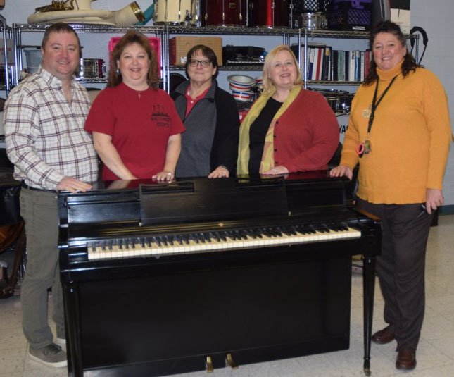 RICK PECK/SPECIAL TO MCDONALD COUNTY PRESS Music students at Noel Elementary and Junior High School surround their new piano after a donation from Whittenburg Church and the I'll Fly Away Foundation. From left to right are Kevin Bernier (I'll Fly Away Foundation), Shelley Jessen (Whittenburg Church), Cathy Little (music teacher at Noel), Betsy Brumley (I'll Fly Away Foundation) and LaDonna McClain (principal at Noel).