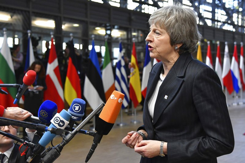 British Prime Minister Theresa May speaks with the media as she arrives for an EU summit in Brussels, Thursday, Dec. 13, 2018. EU leaders gather for a two-day summit, beginning Thursday, which will center on the Brexit negotiations. (AP Photo/Geert Vanden Wijngaert)