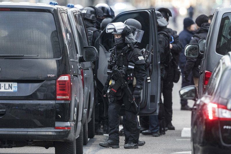 French police forces take position in the Neudorf district of Strasbourg, eastern France, Thursday, Dec. 13, 2018. French security forces were trying to catch the suspected Strasbourg gunman dead or alive as the city of Strasbourg was still in mourning with candles lit and flowers left at the site of Tuesday's attack near the Christmas market.(AP Photo/Jean-Francois Badias)