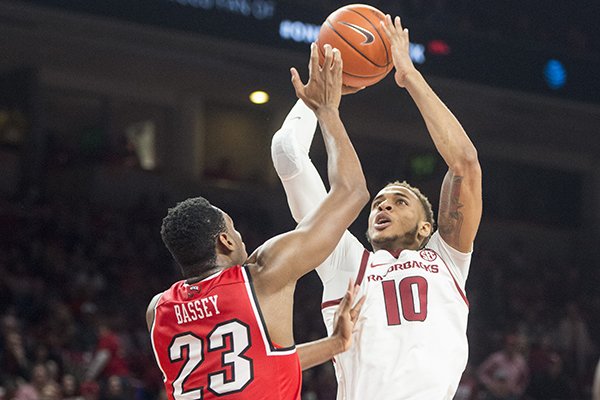 Daniel Gafford of Arkansas shoots as Charles Bassey of Western Kentucky defends in the second half of a game Saturday, Dec. 8, 2018, at Bud Walton Arena in Fayetteville.
