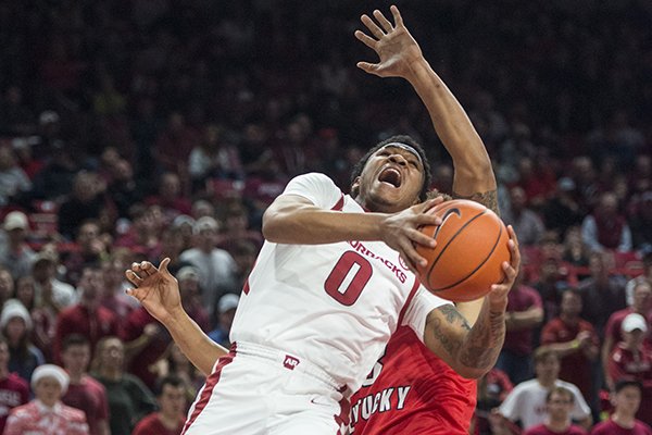 Desi Sills (0) of Arkansas gets fouled by Desean Murray of Western Kentucky in the second half of a game Saturday, Dec. 8, 2018, at Bud Walton Arena in Fayetteville.
