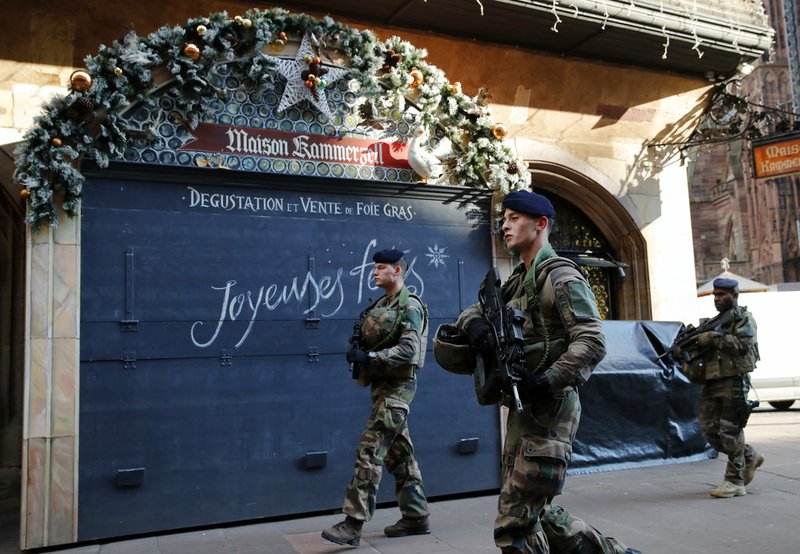 French soldiers patrol in the streets following an attack killing three persons and wounding at least 13, in Strasbourg, eastern France, Thursday, Dec. 13, 2018. Police union officials identified the suspected assailant as Frenchman Cherif Chekatt, a 29-year-old with a thick police record for crimes including armed robbery and monitored as a suspected religious radical by the French intelligence services. (AP Photo/Christophe Ena)