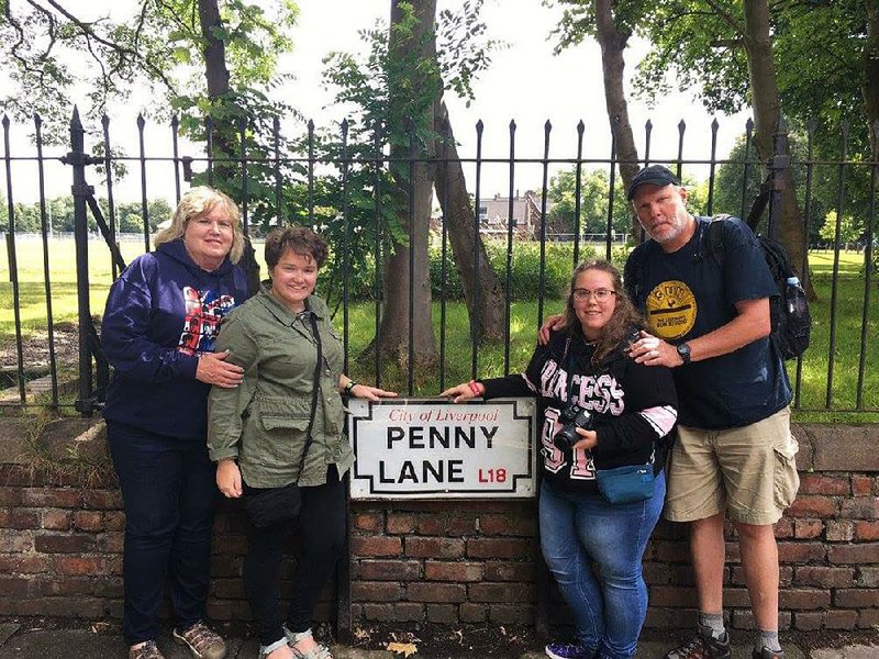 Leslie Taylor poses with daughters Shelby and Jordan and husband Tim Taylor on Penny Lane during the Beatles Magical Mystery Tour on a recent trip to Liverpool, England. Tim wore a Beatles tie to their wedding on May 27, 1994. “We’ve been together almost 30 years and we’ve been married for 25. I’ve never done anything that long in my whole life,” he says. “That’s a tribute to her. She’s my best friend.” 