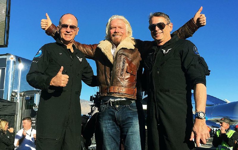 Virgin Galactic founder Richard Branson (center) celebrates with pilots Rick Sturckow (left) and Mark Stucky on Thursday after they landed the six-passenger Virgin Space Ship Unity in the Mojave Desert. 