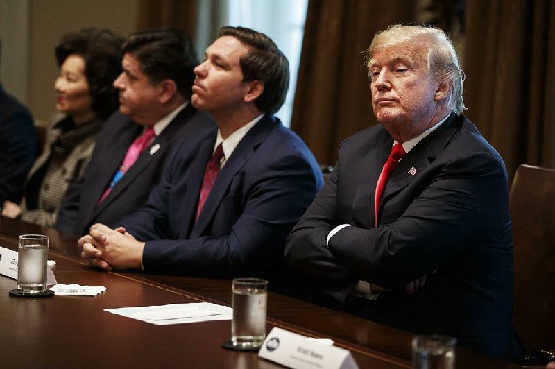President Donald Trump meets with newly elected governors and others Thursday at the White House, including Ron DeSantis of Florida (second from right). In a series of tweets and an interview on Fox News, Trump said he never told former personal attorney Michael Cohen to break the law and said he regrets hiring Cohen. “In retrospect, I made a mistake,” he said. “It happens; I hire usually good people.” 