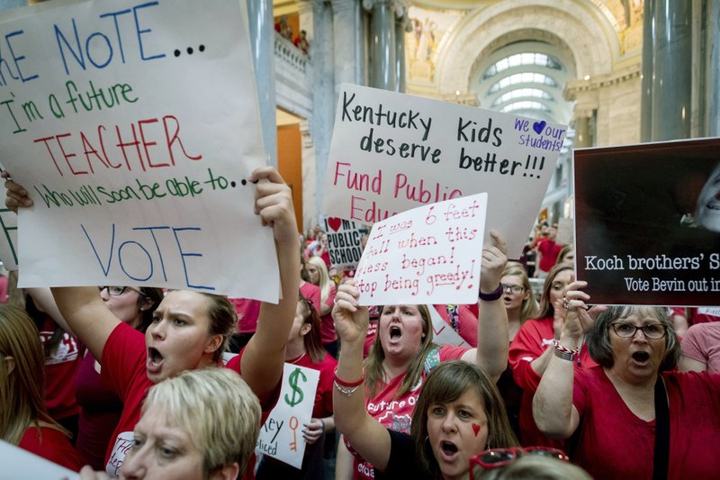 In this April 13, 2018, file photo, teachers from across Kentucky gather inside the state Capitol to rally for increased funding for education in Frankfort, Ky. The Kentucky Supreme Court has struck down a pension law that prompted thousands of teachers to protest at the state Capitol. (AP Photo/Bryan Woolston, File)