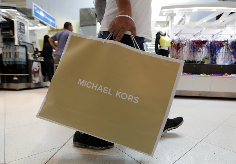 In this Nov. 23, 2018, file photo a shopper walks through Dolphin Mall while shopping on Black Friday in Miami. On Friday, Dec. 14, the Commerce Department releases U.S. retail sales data for November. (AP Photo/Lynne Sladky, File)