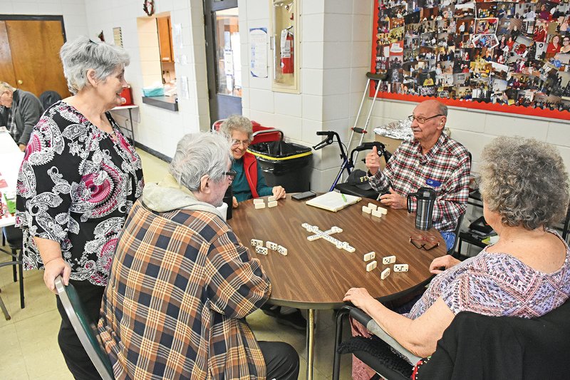 Pamela O’Neal, standing, director of the Bald Knob Senior Center 55-Plus, visits with a group of domino players at the center. The players are David Herdendorf of Bald Knob, clockwise, from left, Evelyn Harms of Bradford, Wendell Smith of Bradford and Connie Green of Bald Knob.