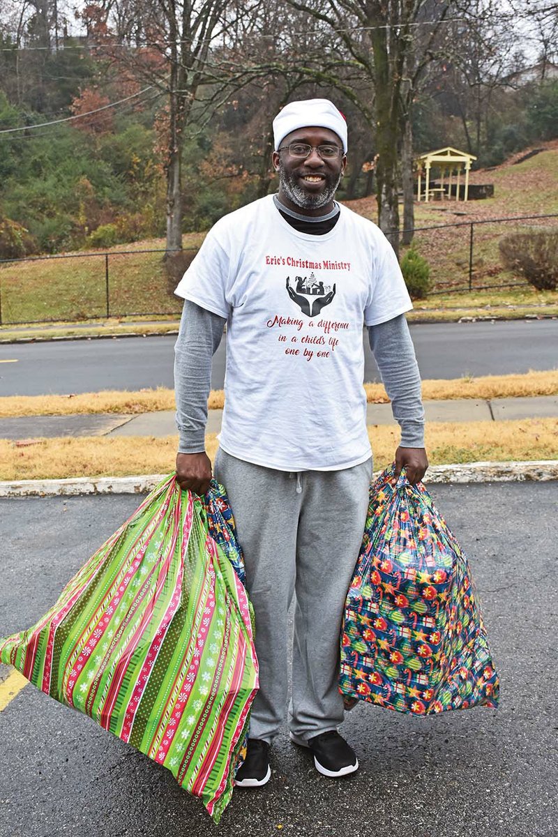 Eric Lamb of Conway holds sacks of toys to give to children living in a hotel in North Little Rock. Lamb said he started Eric’s Christmas Miracles Ministry four years ago when he woke up with a vision from God. He has served more than 575 children since he started and sells his homemade lunches on Fridays to fund part of the mission.
