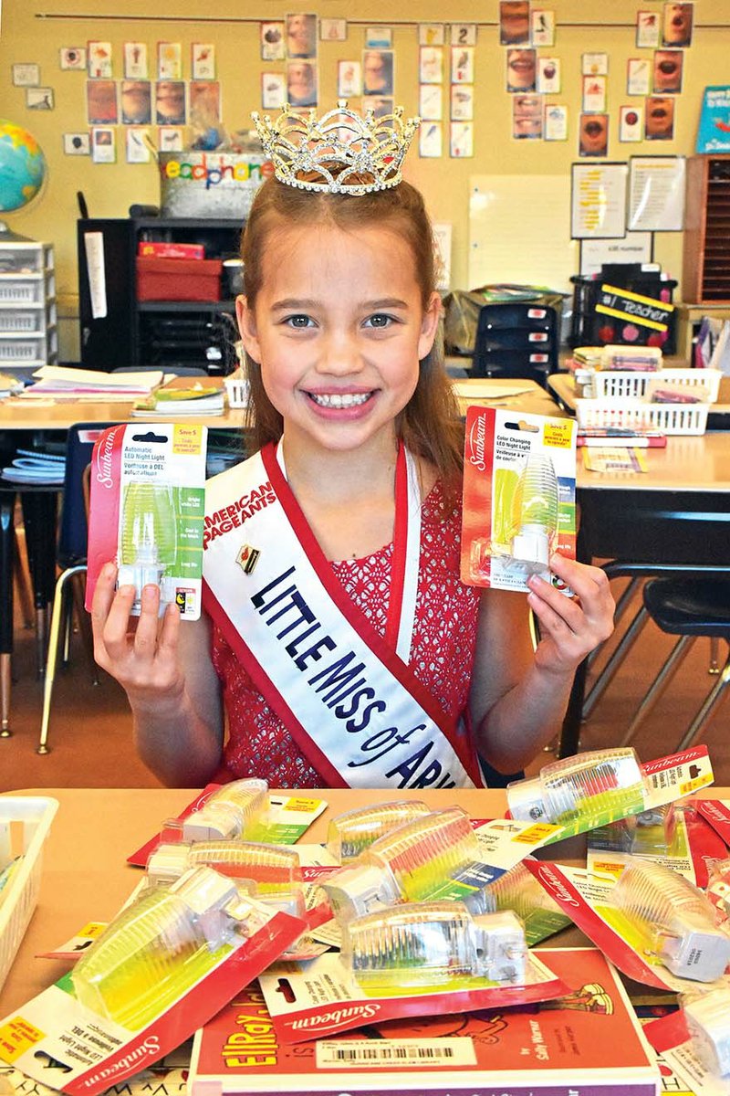 Amelia Lisowe, Little Miss of Arkansas 2018, shows some of the nightlights she purchased through fundraising efforts to support her pageant platform, “Spread a Little Joy.” She donated the nightlights to children in foster care or emergency situations.