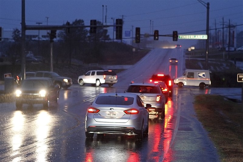 Traffic snarls as automobiles along Hillsboro and Timberlane manually navigate the intersection due to inoperable traffic lights. The west side of the city experienced a power outage Friday evening after a tree fell on an Entergy substation.