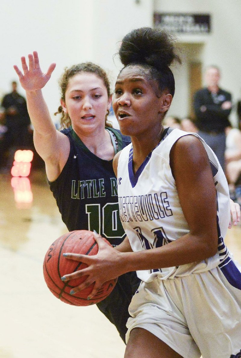 Fayetteville guard Coriah Beck (right) drives to the basket against Little Rock Christian’s Hope Burnett during the Bulldogs’ 73-67 victory over the Warriors on Friday in the Malik Monk Showcase at Tiger Arena in Bentonville.