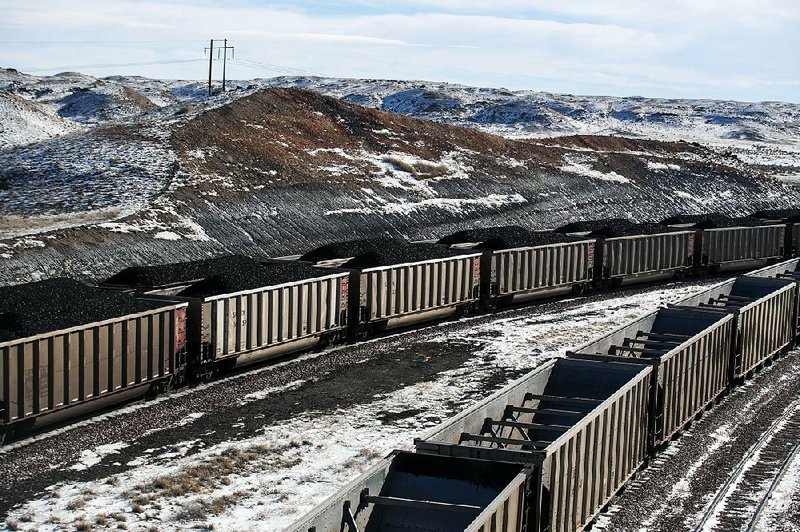 Rail cars are filled with coal and sprayed with a topper agent to suppress dust at Cloud Peak Energy’s Antelope Mine north of Douglas, Wyo. 