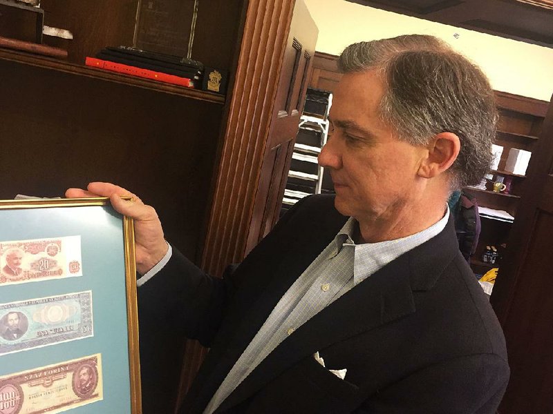 U.S. Rep. French Hill on Friday holds framed currency from Europe’s former communist bloc countries. Hill’s office moved to a different floor in the Longworth Office Building near the U.S. Capitol.