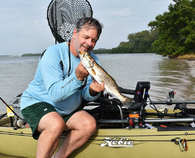 The author admires a speckled trout he caught from a kayak at Fort DeSoto Park near St. Petersburg, Fla.