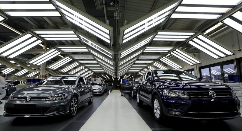 FILE - In this Thursday, March 8, 2018 file photo Volkswagen cars are pictured during a final quality control at the Volkswagen plant in Wolfsburg, Germany. Automaker Volkswagen says it is on track for a new annual sales record despite troubles getting vehicles certified for new European emissions tests. (AP Photo/Michael Sohn, file)