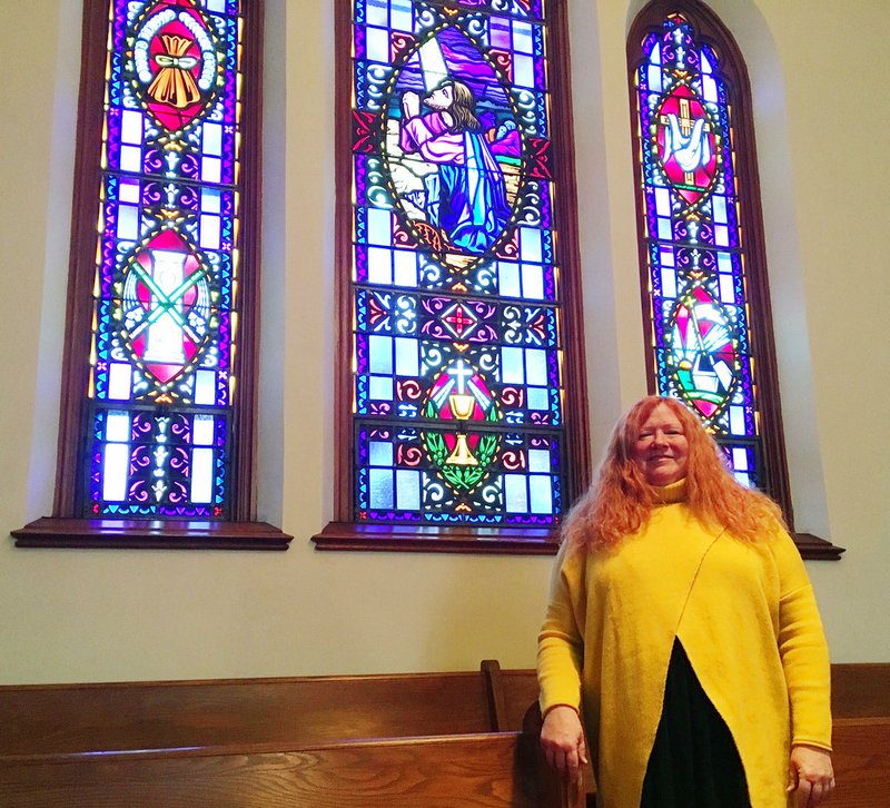 In this Nov. 28, 2018, photo, Cristy Schoob, co-pastor at Trinity Lutheran Church in West Bend, Wis., poses inside the church. A new report shows that women in clergy are becoming a growing trend across the U.S. (Nicholas Dettmann/West Bend Daily News via AP)