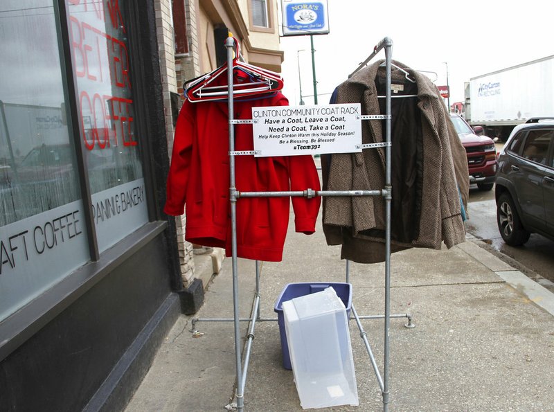 In this undated photo, throughout the day, the the community coat rack in Clinton, Iowa, sits outside 392 Caff&#233;. The coat rack regularly fills and empties, according to 392 Caff&#233; owner Jay Sanders. (Amanda Hancock/Quad City Times via AP)