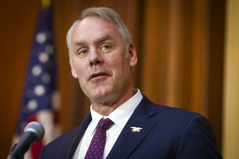 In this Dec. 11, 2018 file photo, Secretary of the Interior Ryan Zinke speaks after an order withdrawing federal protections for countless waterways and wetland was signed, at EPA headquarters in Washington. Trump says on Saturday, Dec. 15, Zinke leaving administration at end of year, successor to be announced next week.(AP Photo/Cliff Owen)