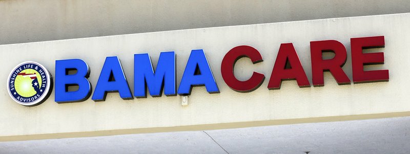 This May 11, 2017, file photo shows an Obamacare sign being displayed on the storefront of an insurance agency in Hialeah, Fla. A conservative federal judge in Texas on Friday, Dec. 14, 2018, ruled the Affordable Care Act "invalid" on the eve of the sign-up deadline for next year. But with appeals certain, even the Trump White House said the law will remain in place for now. In a 55-page opinion, U.S. District Judge Reed O'Connor ruled Friday that last year's tax cut bill knocked the constitutional foundation from under "Obamacare" by eliminating a penalty for not having coverage. The rest of the law cannot be separated from that provision and is therefore invalid, he wrote. (AP Photo/Alan Diaz, File)