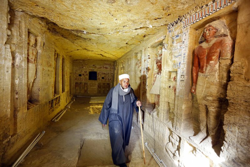 Mustafa Abdo, chief of excavation workers walks at a recently uncovered tomb of the Priest royal Purification during the reign of King Nefer Ir-Ka-Re, named "Wahtye.", at the site of the step pyramid of Saqqara, in Giza, Egypt, Saturday, Dec. 15, 2018. The Egyptian Archaeological Mission working at the Sacred Animal Necropolis in Saqqara archaeological site succeeded to uncover the tomb, Antiquities Minister Khaled el-Anani, announced. (AP Photo/Amr Nabil)