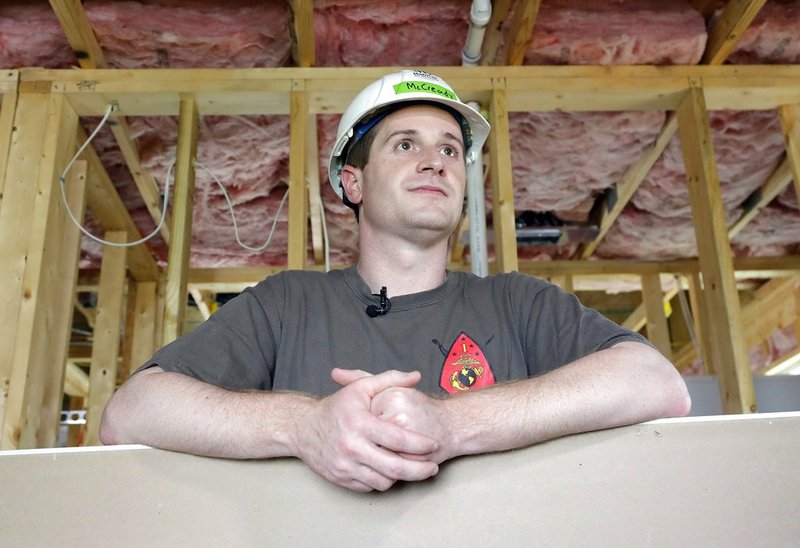 In this Sept. 26, 2018, file photo, Democratic congressional candidate Dan McCready leans against wallboard as he pauses during a Habitat For Humanity building event in Charlotte, N.C. The nation's last unresolved fall congressional race with McCready against Republican Mark Harris is awash in doubt as North Carolina election investigators concentrate on a rural county where absentee-ballot fraud allegations are so flagrant they've put the Election Day result into question. (AP Photo/Chuck Burton, File)