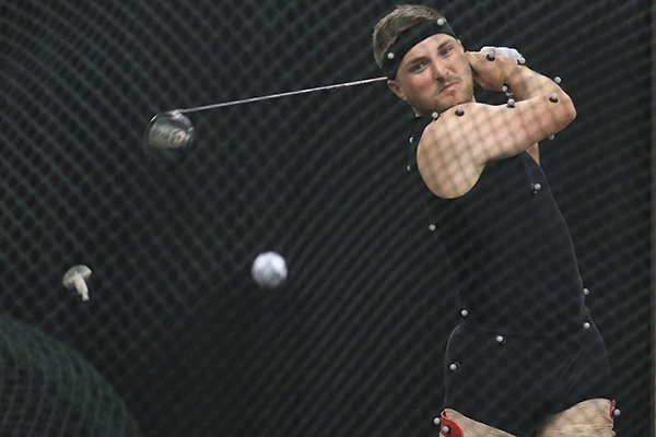 Professional golfer Austin Cook is covered with sensors to capture mechanics of his swing as he hits a golf ball on Friday, Dec. 14, 2018, at HipKnee Arkansas in Little Rock. 