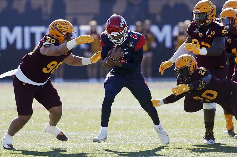 Quarterback Marcus McMaryion (middle) rushed for a touchdown and was 15-of-29 passing for 176 yards to lead No. 21 Fresno State to a 31-20 victory over Arizona State on Saturday in the Las Vegas Bowl.