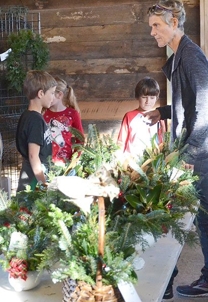 NWA Democrat-Gazette/ Annette Beard Many arrangements and wreaths are available in the wreath barn, a new addition to Wonderland Christmas Tree Farm. Owner Jill Babb said vintage arrangements are particularly popular this year.