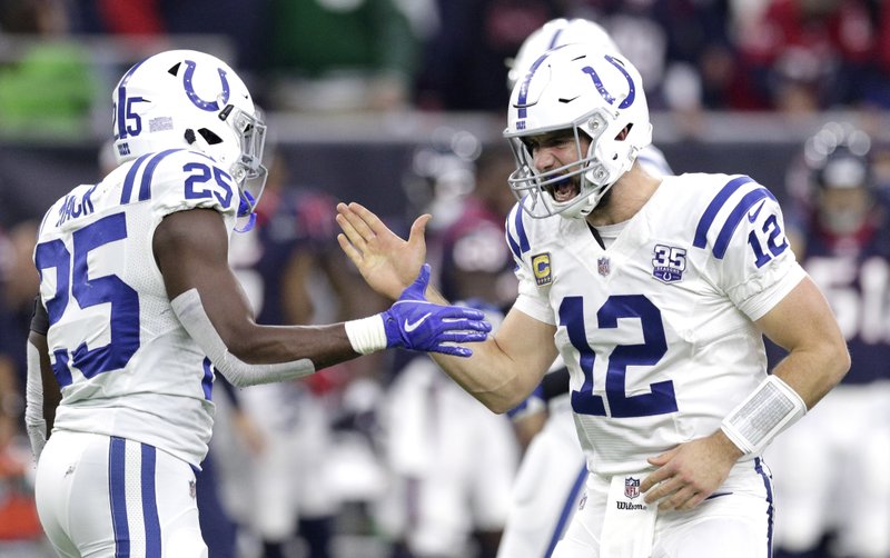 FILE - In this Sunday, Dec. 9, 2018, file photo, Indianapolis Colts quarterback Andrew Luck (12) celebrates with running back Marlon Mack (25) after securing a win against the Houston Texans in the second half of an NFL football game in Houston. In his comeback from a 2017 season lost to a shoulder injury, Luck has been sensational, working behind an offensive line that has gone from sieve to sturdy. AP Photo/Michael Wyke, File)