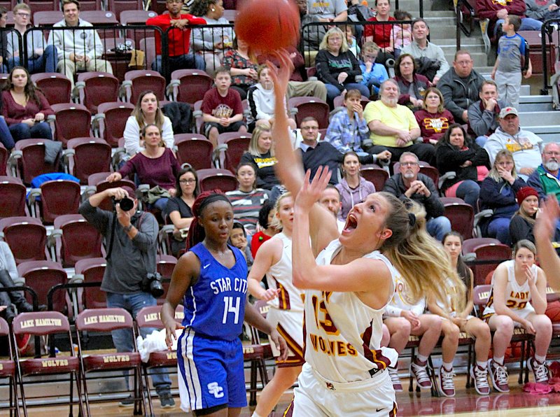 The Sentinel-Record/James Leigh FOUL TROUBLE: Lake Hamilton senior Jenny Peake (13) is fouled Friday night during a shot attempt by Star City senior Kyaira Jackson (23) as the Lady Wolves won, 51-49, at Wolf Arena.