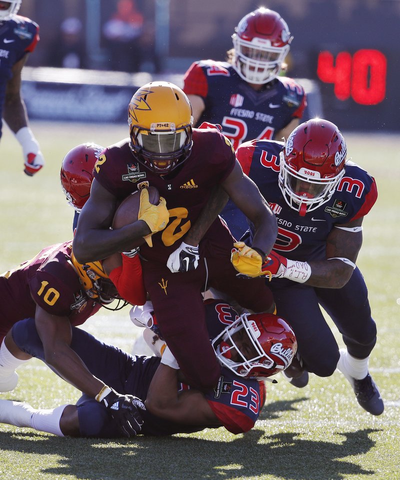 Arizona State wide receiver Brandon Aiyuk is tackled after making a gain against Fresno State during the first half of the Las Vegas Bowl NCAA college football game, Saturday, Dec. 15, 2018, in Las Vegas. (AP Photo/John Locher)