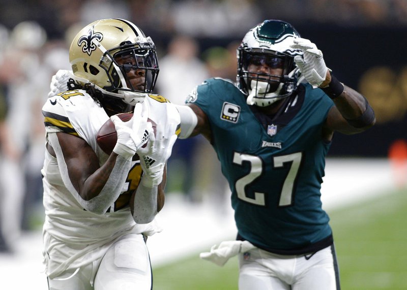FILE - In this Nov. 18, 2018, file photo, New Orleans Saints running back Alvin Kamara (41) pulls in a touchdown reception in front of Philadelphia Eagles strong safety Malcolm Jenkins (27) during the second half of an NFL football game in New Orleans. Kamara figures to play a prominent role in the Saints game Monday, Dec. 17, night at Carolina .(AP Photo/Bill Feig, File)