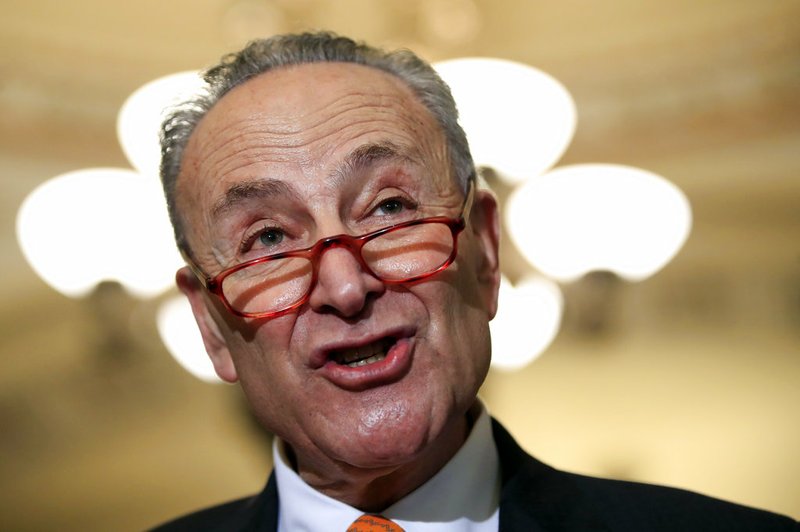 In this Dec. 11, 2018 photo, Senate Minority Leader Chuck Schumer, D-N.Y., speaks to reporters on Capitol Hill in Washington. Parties and Christmas cookies only soothe so much in the chilly Capitol after two years of President Donald Trump's provocations, dramas like Supreme Court Justice Brett Kavanaugh's confirmation and the elections that flipped the House majority to Democrats. Everyone wants to go home, yet both chambers were scheduled to be in session next week over hefty matters, including the budget and criminal sentencing reform. (AP Photo/Manuel Balce Ceneta)