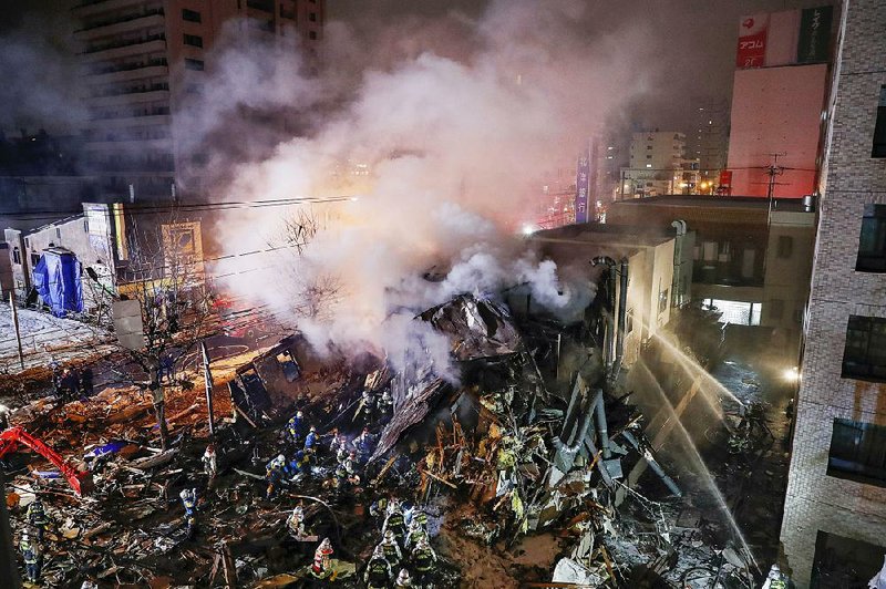First responders work at the scene of Sunday’s explosion in Sapporo, Japan. 