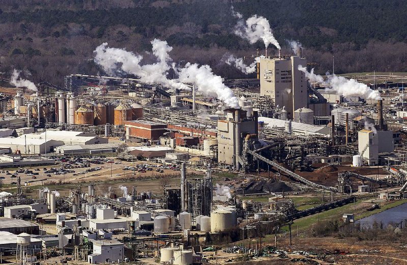 Fumes rise from the Georgia-Pacific paper mill in Crossett in March. Under a consent decree filed Friday by the U.S. Environmental Protection Agency and the Arkansas Department of Environmental Quality, the mill must pay $600,000 in fines, make upgrades to reduce air pollutants and spend $1.8 million on environmental projects, including a 600,000-gallon tank to collect waste products. 