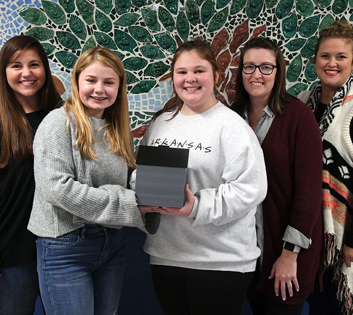 The Sentinel-Record/Grace Brown- Lakeside Middle School students Brionna Mattingly, 13, 2nd from left, and Reese Vines, 13, hold up their 3D printed donation box for the Our Promise House at Lakeside Middle School on Thursday, December 13, 2018. They are joined by Sara Runyon with the Debutante Courtier, left, EAST facilitator Melissa Ellis, and Stacey Pierce with Our Promise. 