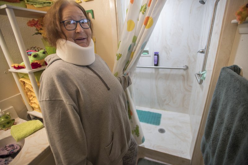 NWA Democrat-Gazette/J.T. WAMPLER Judy Thiara shows off her newly remodeled shower Wednesday in her apartment at Phillips Plaza in Springdale. The Springdale Housing Authority spent $247,000 this year updating the bathrooms in 26 units at Phillips Plaza, said Mary James, director of the public housing program.